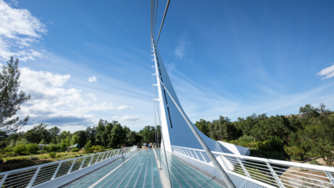 Eyeing the far end of a modern footbridge. Humans and other animals have been building footbridges for thousands of years. With modern innovation, they are re-emerging all over the world.​ Keywords: human-built expansive; wide; sustainable; sustainability; architecture; architectural; California; suspension; clean air; infrastructure; landscape