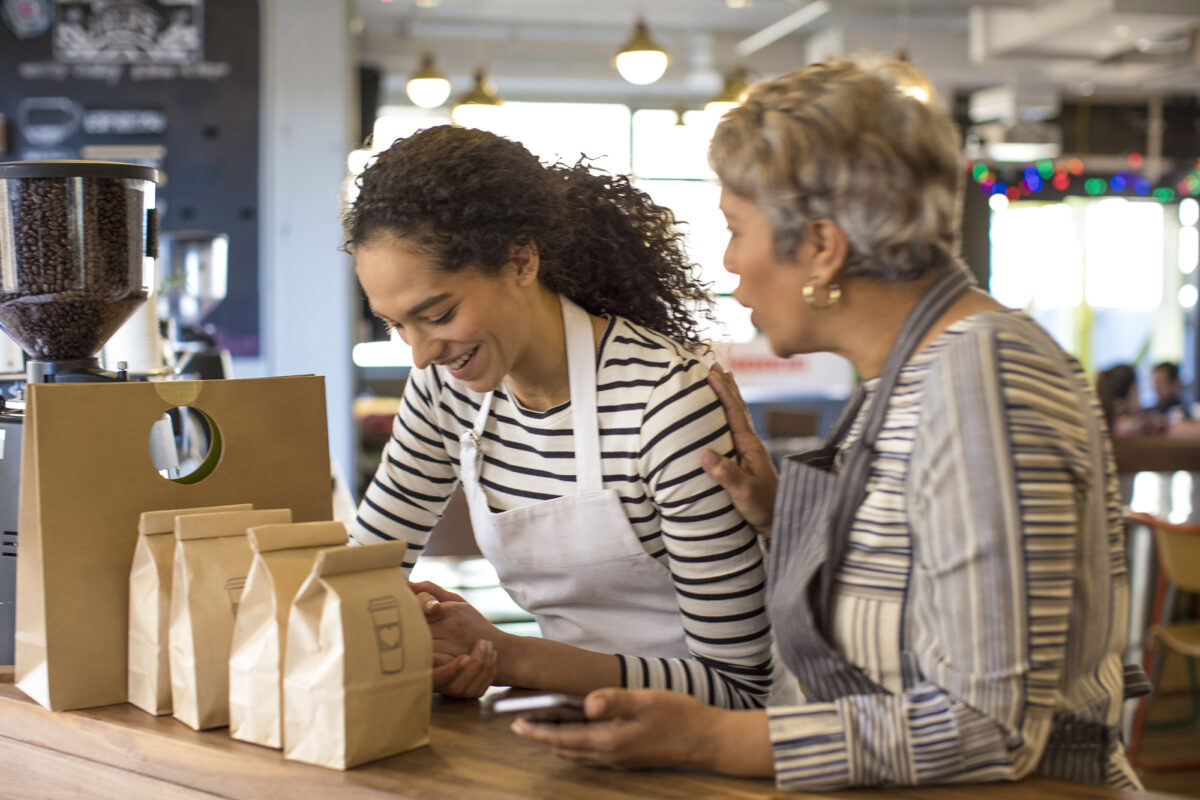 Frontline worker achieving in retail work space using phone. Mobile inventory. Coffeshop owner. Small Business. Collaboration.